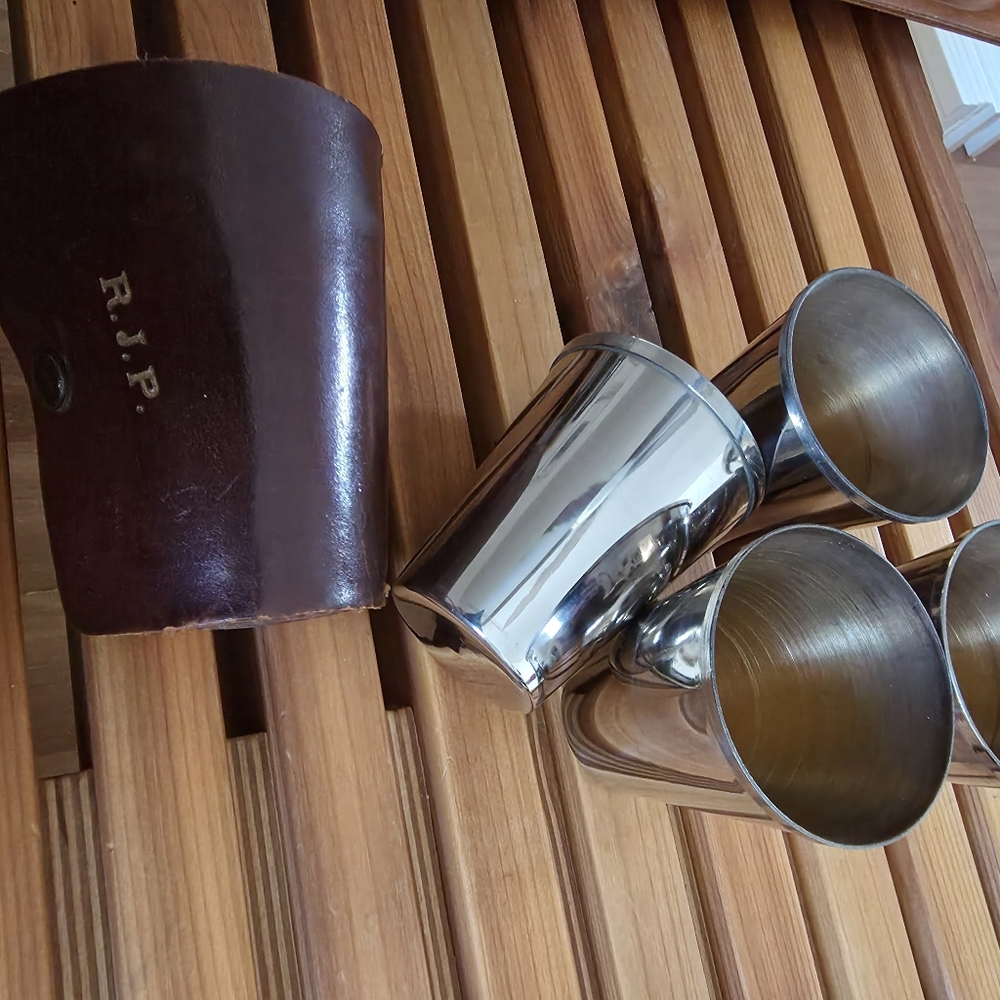 Vintage set of stainless steel nesting shot glasses in a leather carrying Case